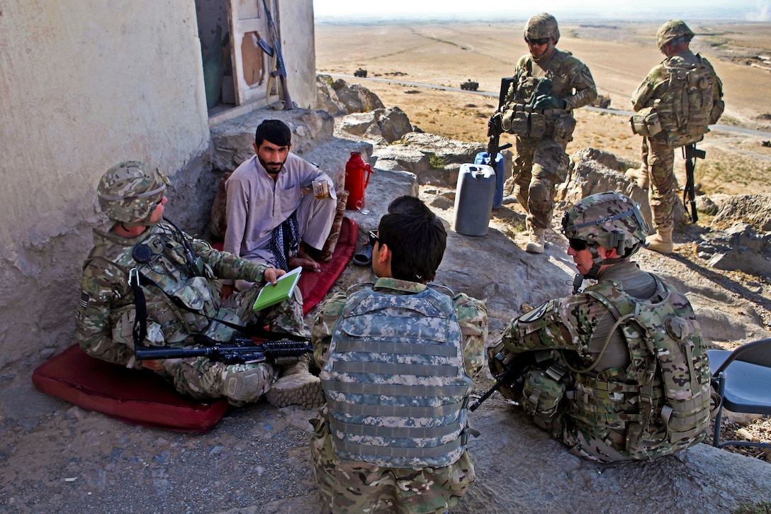 U.S. soldiers conduct a meeting with Afghan national police in Bagram in Afghanistan's Parwan province, Sept. 7, 2013. The national police, a critical element of Afghan security forces, have assumed responsibility for security throughout Afghanistan.  
