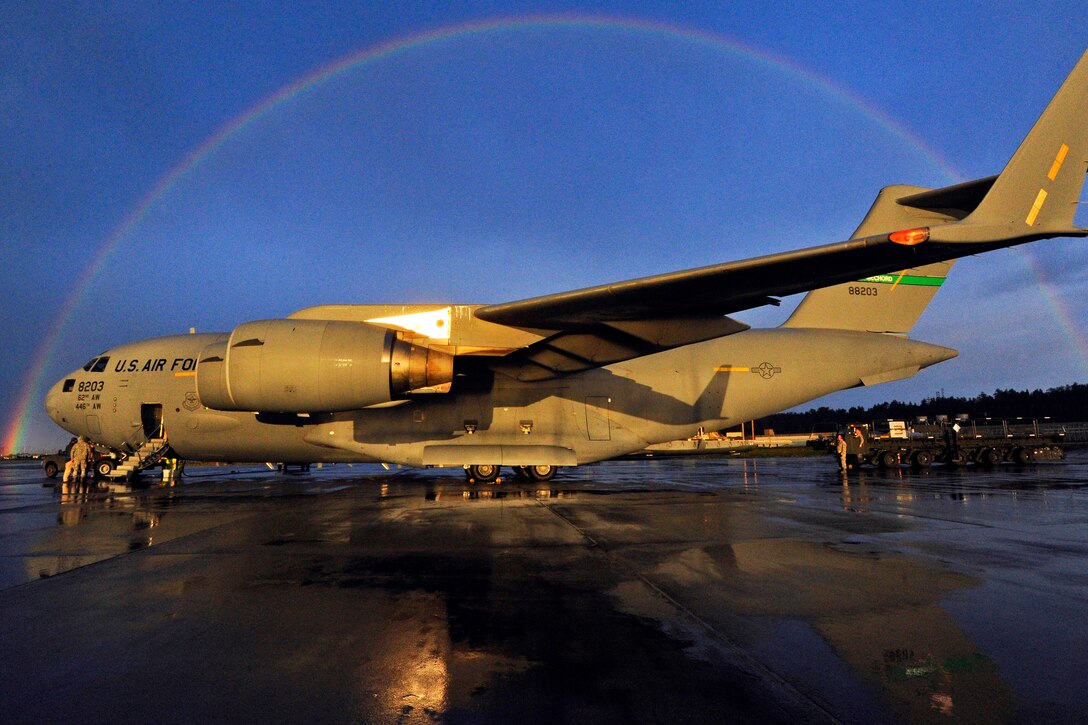 A rainbow appears in the sky framing a U.S. Air Force C-17 Globemaster III aircraft on the flightline on Joint Base Elmendorf-Richardson, Alaska, Sept. 10, 2013, as soldiers wait to off-load Strykers. The soldiers, assigned to the 1st Stryker Brigade Combat Team, 3rd Battalion, 21st Infantry Regiment, were transported with their Strykers from Fort Wainwright, Alaska, to participate in a combat training exercise with the 4th Infantry Brigade Combat Team.  
