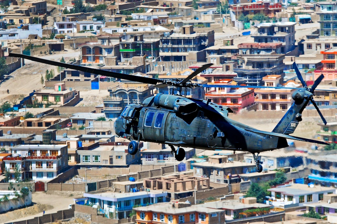 U.S. Army 1st Lt. Chuck Nadd, U.S. Army Chief Warrant Officer 4 Darren Dreher, U.S. Army Staff Sgt. Bruce Kleckner and U.S. Army Sgt. Jay Herring fly a UH-60L Black Hawk helicopter to move personnal over Kabul, Afghanistan, Sept. 4, 2013. Nadd and Dreher, pilots, and Kleckner and Herring, crew chiefs, are assigned to Company A, 2nd Battalion General Support, 104th Aviation Regiment.  
