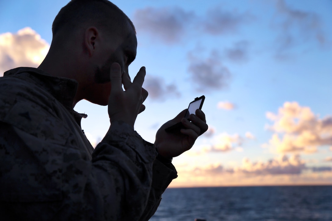 Marine Corps Lance Cpl. Ryne Larson applies camouflage paint to his face before conducting an amphibious training raid for Tropic Thunder, an exercise on Marine Corps Base Hawaii, Kaneohe Bay, Aug. 30, 2013. Larson, a team leader, is assigned to Bravo Company, Battalion Landing Team, 1st Battalion, 4th Marine Regiment, 13th Marine Expeditionary Unit.  
