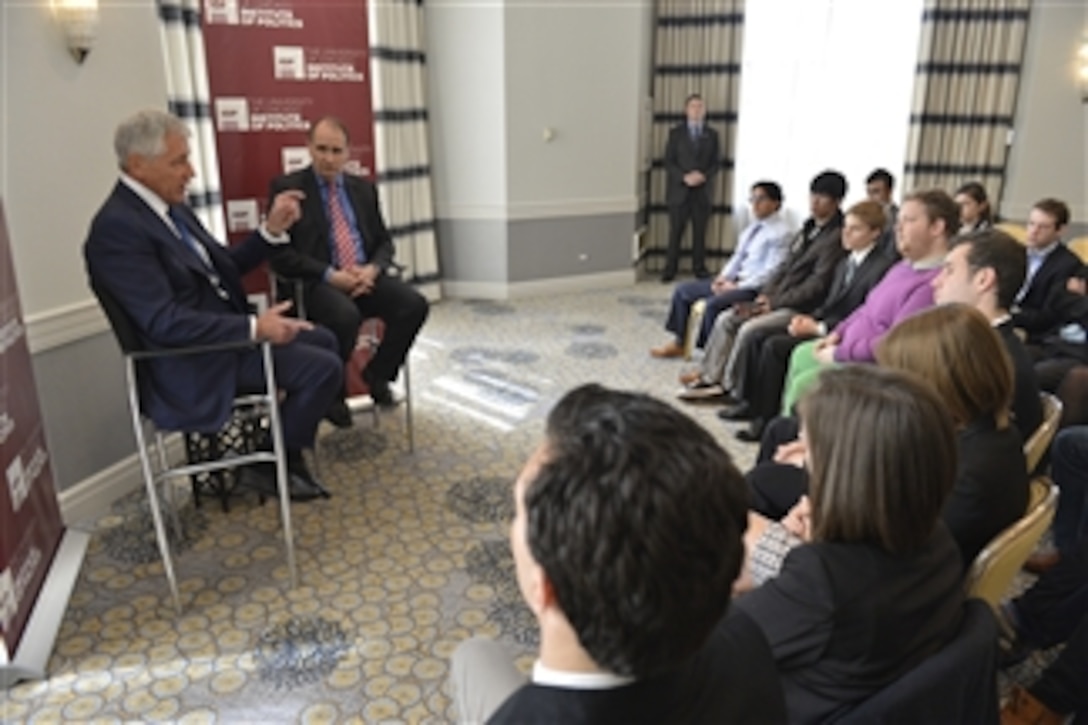 Defense Secretary Chuck Hagel participates in a discussion with members of the University of Chicago's Institute of Politics in Chicago, May 6, 2014. David Axelrod, right, the institute's director and a political consultant, hosted the event.