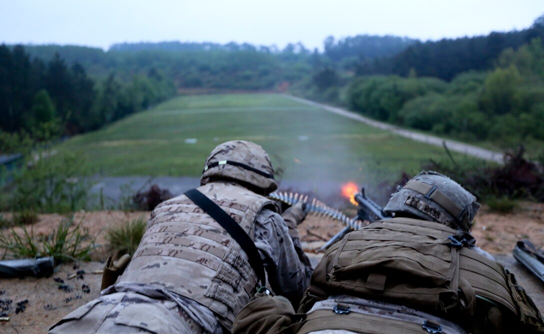 U.S. Marine Corps Lance Cpl. Jered Bass, a machine gunner with Special-Purpose Marine Air-Ground Task Force Crisis Response, fires an array of light machine guns with soldiers from the Spanish Army Light Infantry Battalion as part of a bilateral training exercise on Asturias, Spain, April 29, 2014. The training  was conducted to further partnership and interoperability between SP-MAGTF CR and the Spanish forces. (U.S. Marine Corps photo by Lance Cpl. Alexander Hill/Released)
