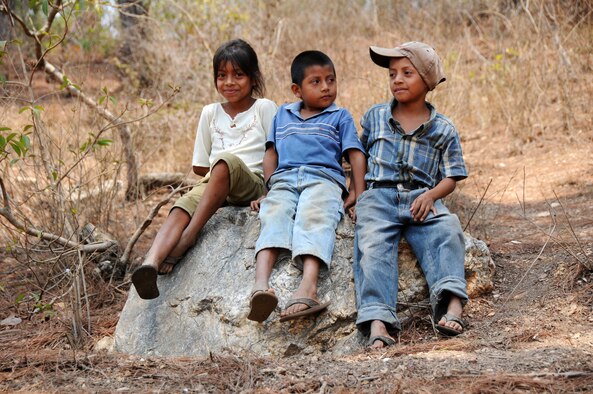 Guatemalan children watch as Airmen with the 188th Civil Engineer Squadron load cinder blocks in preparation to build a school April 14, 2014, in El Robles, Guatemala, in support of Beyond the Horizon. Beyond the Horizon is a U.S. partnership with the government of Guatemala conducting various medical, dental and civic actions programs, providing focused humanitarian assistance. (U.S. Air National Guard photo/Maj. Heath Allen)