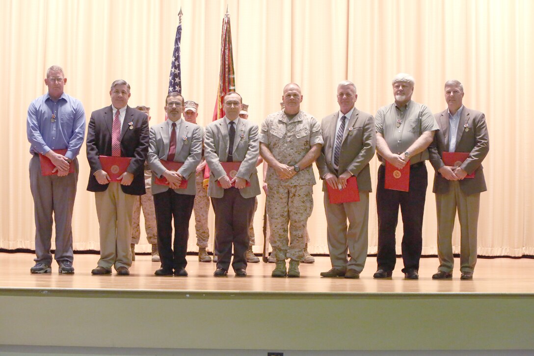 Lieutenant Gen. Robert Neller, commander of U.S. Marine Corps Central Command, presented the Secretary of Defense Medal for the Global War on Terrorism to nine MARCENT "Civilian" Marines  at the base theatre aboard
MacDill Air Force Base, May 6. With the civilian service medals pinned to their chests, Lt. Gen. Neller posed with the recipients. Pictured left to right, were Don Lorkowski, Jerry Lyons, John Marques, Terry Moores,  Charles "Gramps" Peterson, Ben Philhower, and Allen Rupenski. Notable guests at the ceremony were Gen. John Paxton, Assistant Commandant of the Marine Corps, and Brig. Gen. John Jansen, Assistant Deputy Commandant for Programs and Resources.  Not present, but also recipients of medal, were Jeff "Bird" Hibbard and Jim McSpadden.
The medal was established by the Secretary of Defense to recognize the contributions and accomplishments of civilian employees of the DoD in direct support of the armed forces engaged in operations to combat terrorism, since Sept. 11, 2001. 
