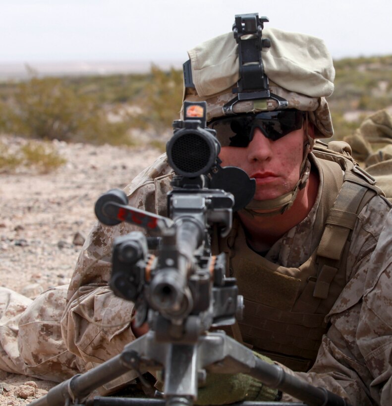 Reading, Penn., native Pfc. Cody Troxel, a machine gunner with Echo Company, 2nd Battalion, 8th Marine Regiment, 2nd Marine Division, poses behind his M240 Bravo machine gun during a dry-run exercise at Range 62, on Fort Bliss, Texas, April 5, 2014. As a machine gunner, Troxel, also works with the M249 Squad Automatic Weapon, the Browning M2 .50 caliber machine gun, and the Mk-19 automatic grenade launcher.