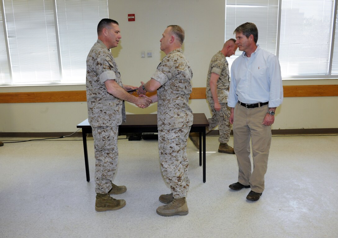 Brigadier General John W. Simmons, Commanding General ,Training Command, Presents the Safety Excellence award to Colonel John R. Giltz, Commanding officer, Marine Corps Detachment Fort Leonard Wood.