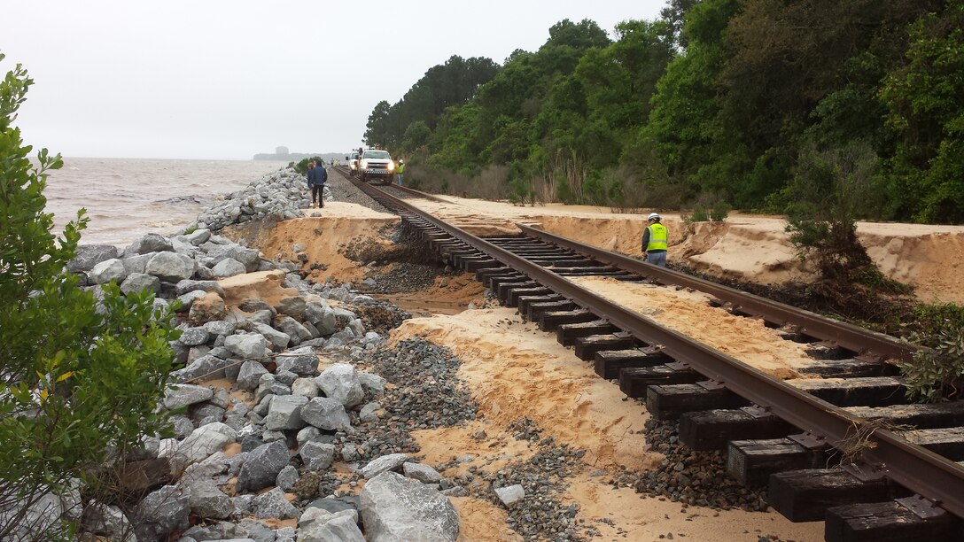 Corps initiates emergency permitting program in response to April storm, which left severe damages in its wake, like those shown here on the railroad tracks adjacent to the road washout on the Scenic Highway in Pensacola.