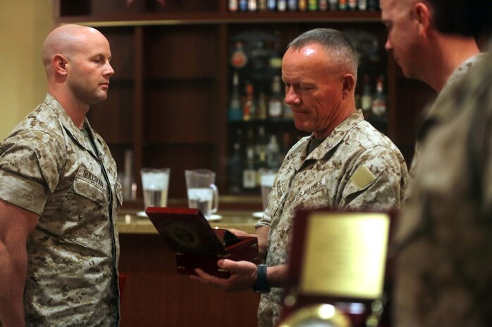 Major Gen. Lawrence D. Nicholson, center, the commanding general of 1st Marine Division, awards Sgt. Michael Sullivan, left, a motor transportation maintenance chief with 3rd Combat Engineer Battalion, the 2013 Marine Corps Motor Transport Association’s Maintenance Chief of the Year award during an award ceremony aboard Marine Corps Base Camp Pendleton, Calif., April 30, 2014. Sullivan, a 28-year-old native of Festus, Mo. earned the award for his acute attention to detail. He successfully oversaw 115 motor transport assets that valued more than $13 million. Despite having such a mountainous task, he still helped encourage and train Marines throughout his shop.