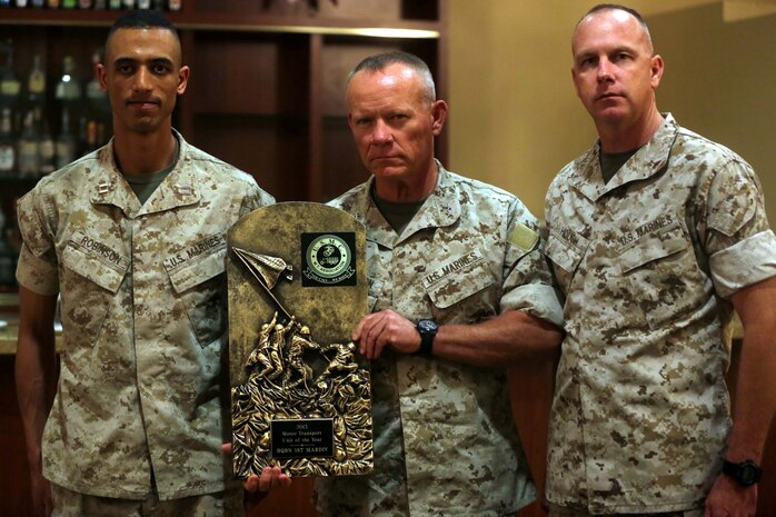 Major Gen. Lawrence D. Nicholson, center, the commanding general of 1st Marine Division, awards Capt. Frank Robinson, left, the commanding officer of Truck Company, Headquarters Battalion, 1st Marine Division, the Marine Corps 2013 Motor Transportation Association’s Unit of the Year award during an award ceremony aboard Marine Corps Base Camp Pendleton, Calif., April 30, 2014. The company earned the award for demonstrating exceptional technical and tactical proficiency and dependability.