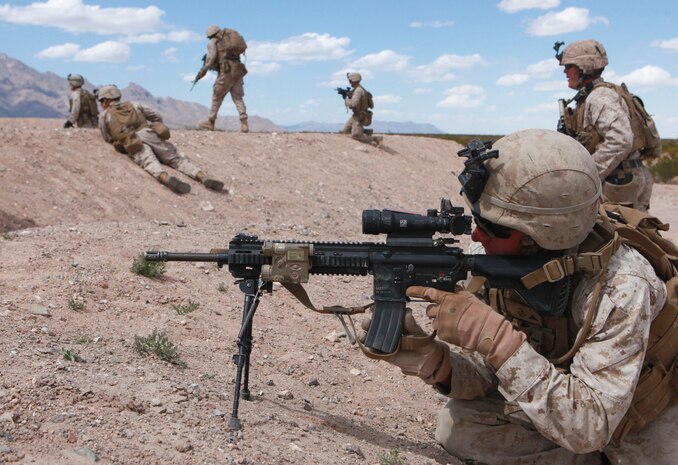 Lance Cpl. Allen Richmond, an automatic rifleman, with Echo Company, 2nd Battalion, 8th Marine Regiment, provides cover for Marines moving forward while assaulting the enemy during mission rehearsals at Range 62, on Fort Bliss, Texas, April 5, 2014.