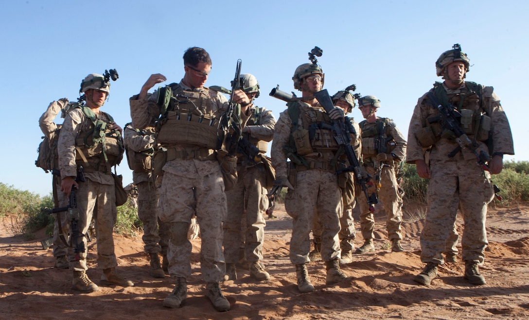 Marines with Fox Company, 2nd Battalion, 8th Marine Regiment, 2nd Marine Division, prepare to load an amphibious assault vehicle to move to a town for a training exercise later that night on Fort Bliss, Texas, April 28, 2014. Marines moved into position under the cover of night over tough terrain to conduct an assault on a village in order to eliminate enemy forces occupying it. The village was key to future operations in the area and allowed control of Route Grey, a main route for coalition operations in the area. 