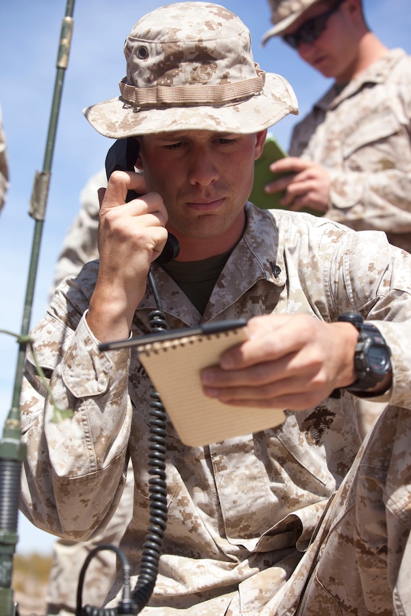 Corporal Jonathan Hoag, a squad leader with Fox Company, 2nd Battalion, 8th Marine Regiment, calls for close air-support from AH-64 Apache helicopters with Alpha Company, 1-501st Aviation Regiment, 1st Armored Division, overhead during close air-support training at Dona Anna training facility on Fort Bliss, Texas, April 24-26, 2014. Close air-support will be available to the battalion’s companies throughout training and sometimes during the Network Integration Exercise beginning in May. Squad leaders, platoon commanders, fire support team leaders, and joint fire observers were able to train with the helicopters for two days in preparation for use in upcoming training.