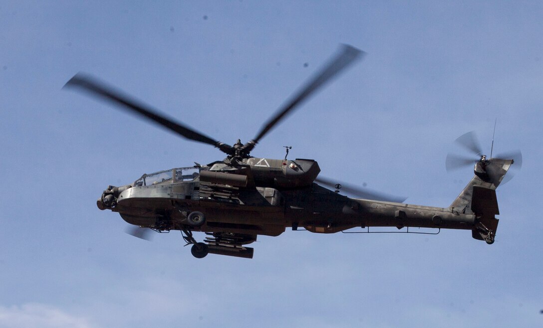 An AH-64 Apache helicopter with Alpha Company, 1st Battalion, 501st Aviation Regiment, 1st Armored Division, hovers while supporting a close air-support training exercise with 2nd Battalion, 8th Marine Regiment, 2nd Marine Division at Dona Anna training facility on Fort Bliss, Texas, April 24-26, 2014. Close air-support will be available to the battalion’s companies throughout training and sometimes during the Network Integration Exercise beginning in May. Squad leaders, platoon commanders, fire support team leaders, and joint fire observers were able to train with the helicopters for two days in preparation for use in upcoming training.