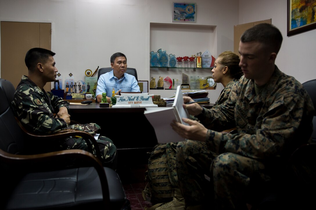 Vittorio Roces, center, discusses donations of medical supplies to the Bigaa Health Center with Philippine Army Capt. Virgilio Perez, left, and U.S. Marine Maj. Grace Janosek May 5 in Bigaa, Albay province, Philippines. The donations were a part of the humanitarian civil assistance programs held during Exercise Balikatan, an annual bilateral training exercise held with Philippine and U.S. forces to strengthen the relationship between the two nations. “It’s an honor to receive this assistance in Legazpi City,” said Roces, the acting mayor of Legazpi City. Perez is a civil affairs officer with 9th Infantry Division, and Janosek is a civil affairs team leader with civil affairs detachment, G3, III Marine Expeditionary Force. 