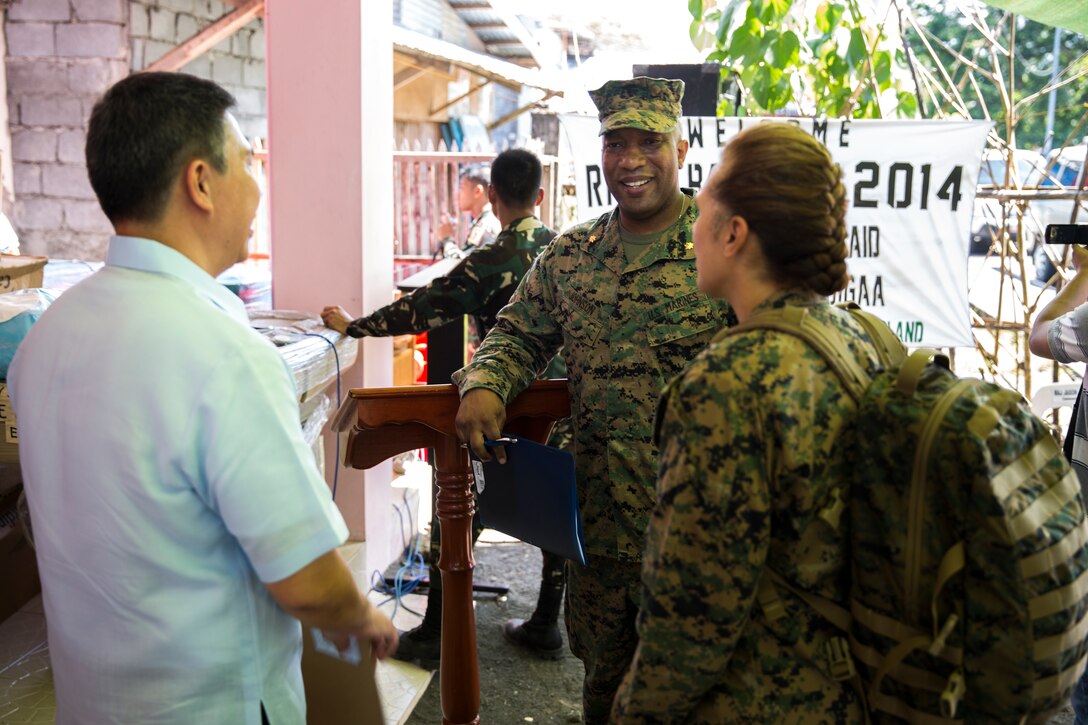 Vittorio Roces, left, talks with U.S. Marine Majs. Jason Johnson and Grace Janosek about the medical supply donations being made at the Bigaa Health Center May 5 in Bigaa, Albay province, Philippines. The donations were a part of the humanitarian civil assistance programs being completed during Exercise Balikatan, an annual bilateral training exercise between the Philippine and U.S. forces to strengthen the relationship between the two allied nations. Roces is the acting city mayor of Legazpi, Johnson is deputy commander for the Joint Civil Military Operations Task Force, U.S. armed forces, and Janosek is a civil affairs team leader with civil affairs detachment, G3, III Marine Expeditionary Force.