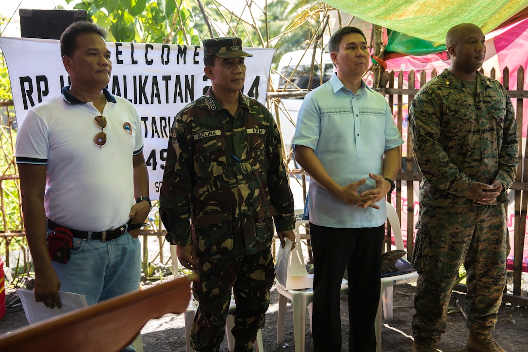 (Left to right) Roberto Arienda, Philippine Army Col. Generoso Bolina, Vittorio Roces, and U.S. Marine Maj. Jason Johnson stand together May 5 as the medical supply turnover ceremony begins at the Bigaa Health Center in Bigaa, Albay province, Philippines. The donations were a part of the humanitarian civil assistance programs being completed during Exercise Balikatan, an annual bilateral training exercise between the Philippine and U.S. forces to strengthen the relationship between the two allied nations. Arienda is the barangay chairman of Bigaa, Bolina is deputy commander of the Joint Civil Military Operations Task Force, Armed Forces of the Philippines, Roces is the acting city mayor of Legazpi and Johnson is deputy commander for the JCMOTF, U.S. armed forces.