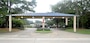 This artist rendering shows six columns for the under construction main gate shelter, while the finished overhead protective cover will be supported by two additional middle columns for a total of eight.