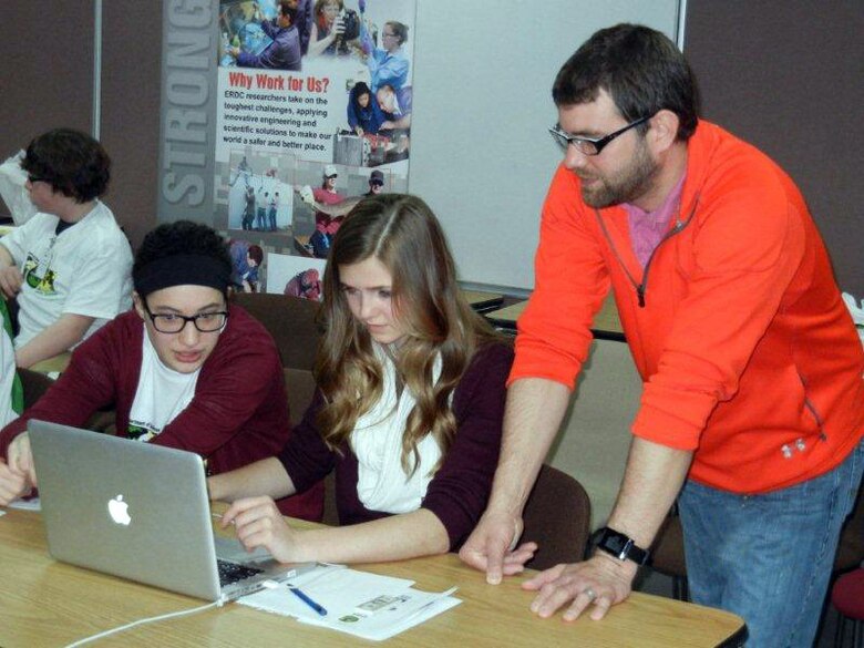 An Urbana Middle School teacher helps students get started with the DimensionU tools.  