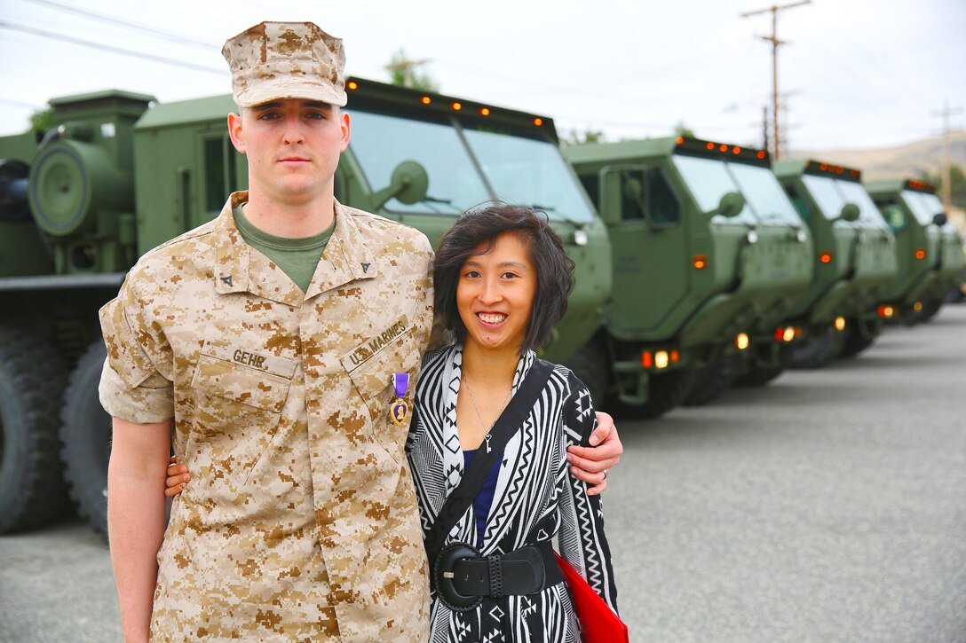Lance Cpl. Gabriel R. Gehr, electrical equipment system technician with Utilities Platoon, Engineer Maintenance Company, 1st Maintenance Battalion, 1st Marine Logistics Group, poses with his wife, Kaitlyn, after receiving the Purple Heart aboard Camp Pendleton, Calif., May 5, 2014. More than a year earlier on Nov. 20, 2013, Gehr sustained shrapnel injuries from an anti-tank rocket while supporting Operation Enduring Freedom. Gehr, 21, is from Delphos, Ohio.