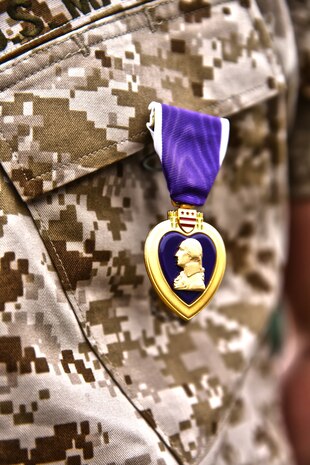 Lance Cpl. Gabriel R. Gehr, electrical equipment system technician with Utilities Platoon, Engineer Maintenance Company, 1st Maintenance Battalion, 1st Marine Logistics Group, wears the Purple Heart after receiving the medal aboard Camp Pendleton, Calif., May 5, 2014. More than a year earlier on Nov. 20, 2013, Gehr sustained shrapnel injuries from an anti-tank rocket while supporting Operation Enduring Freedom.