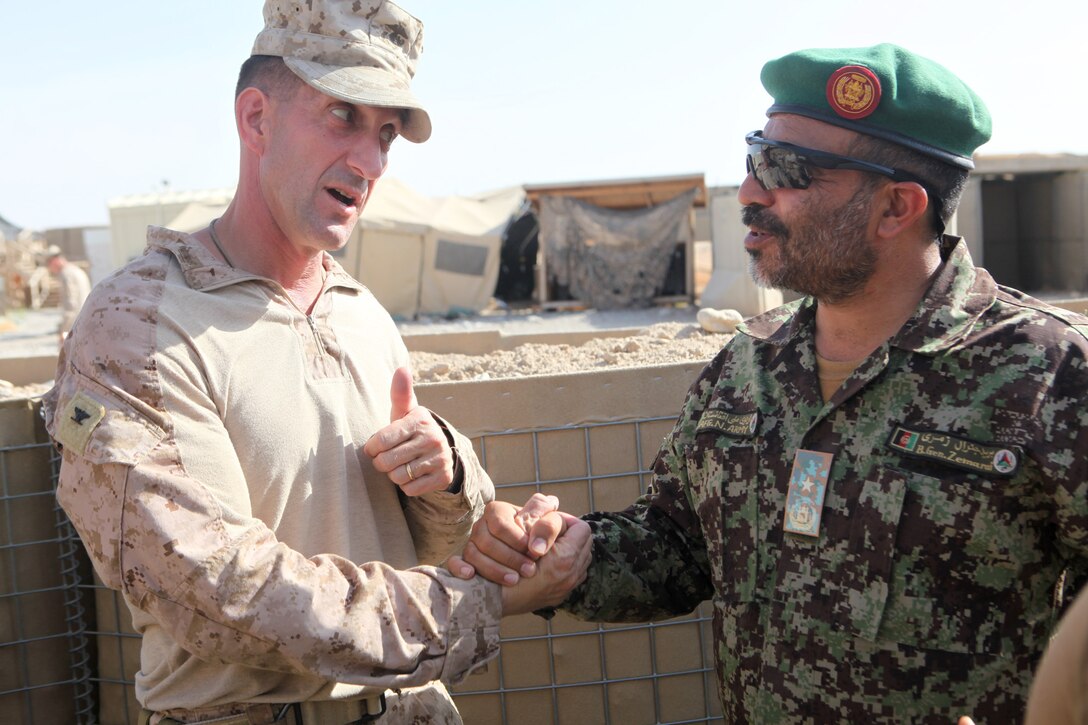 Colonel Christopher Douglas, from Ballston Spa, New York, and the team leader of Security Force Assistance Advisor Team 2-215, wishes Brig. Gen. Zamarai Khan Tarz the best of luck prior to leading his team out of Forward Operating Base Nolay, Helmand province, Afghanistan, May 4, 2014. Douglas took Brig. Gen. Zamarai on a tour of the base before turning it over to him and the 2nd Brigade, 215th Corps, Afghan National Army.