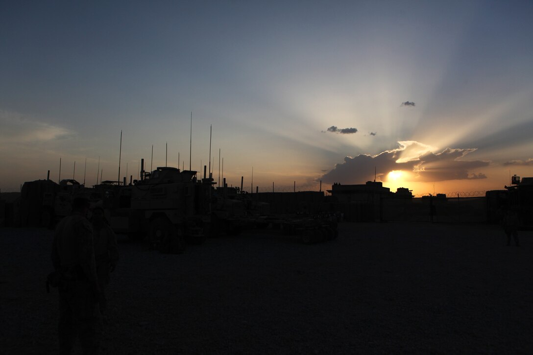 Trucks wait in place as the sun sets on Forward Operating Base Nolay for the last time before Security Force Assistance Advisor Team 2-215 exits the Sangin Valley, Helmand province, Afghanistan, May 4, 2014. The service members with SFAAT 2-215 are completing a seven-month deployment as the last advisors in support of the 2nd Brigade, 215th Corps, Afghan National Army.