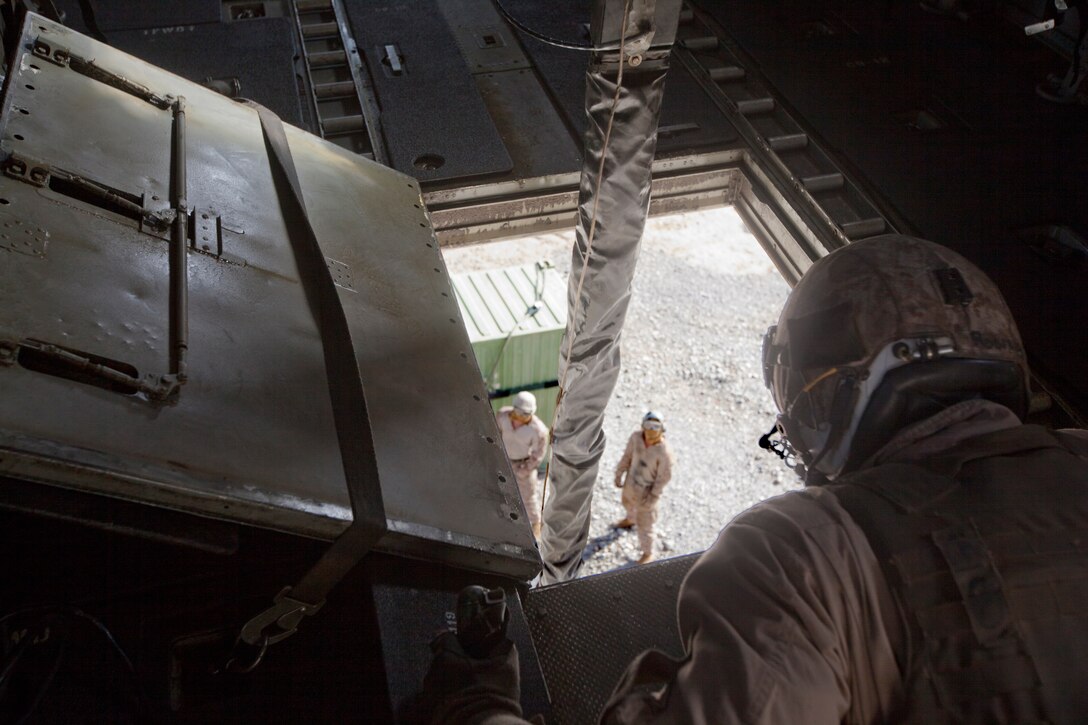 Corporal Ryan Roberts, right, a CH-53E Super Stallion avionics collateral duty inspector with Marine Heavy Helicopter Squadron 466 and an Orlando native, watches as Marines prepare to attach a shipping container for an external lift of equipment out of Forward Operating Base Sabit Qadam in the Sangin Valley of Helmand province, Afghanistan, May 3, 2014. The last Marines, sailors and equipment exited FOBs Nolay and Sabit Qadam, May 5, 2014, leaving the 2nd Brigade, 215th Corps, Afghan National Army in full control of the FOBs and the surrounding area for the first time without advisors in place since coalition forces entered during 2006. (U.S. Marine Corps Photo By: Sgt. Frances Johnson/Released)