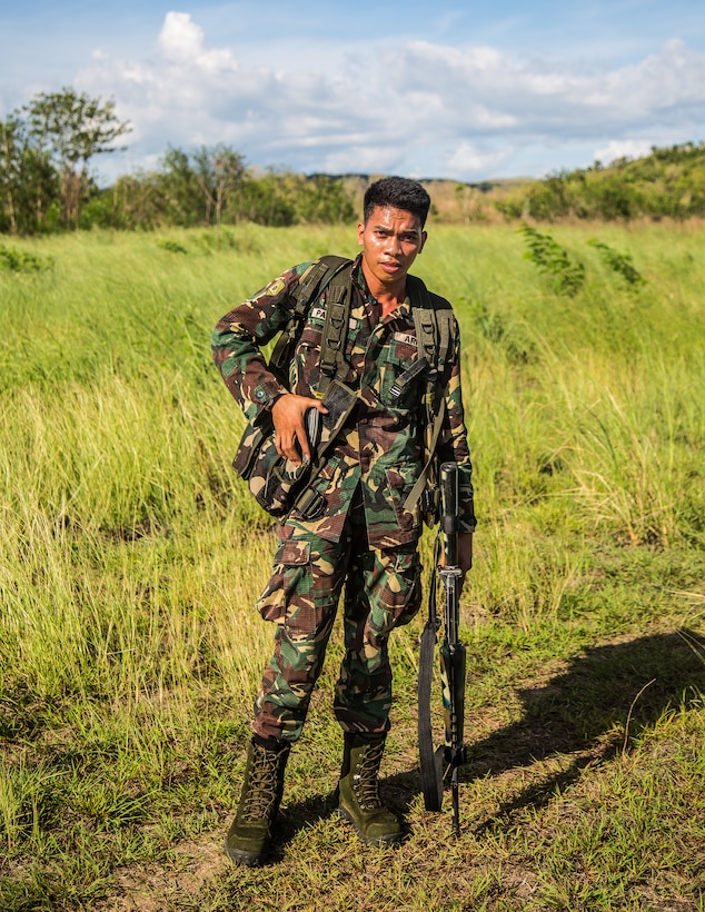 Philippine Army Pfc. Joedanh Panican, Charlie Company, 20th Infantry Battalion, rests after air assault training with U.S. Soldiers at Fort Magsaysay, Philippines, May 5, 2014. Philippine Soldiers of Charlie Company, 20th Infantry Battalion bound forward in squad elements to engage pop-up targets during Balikatan 2014. This year marks the 30th iteration of the exercise, which is an annual Republic of the Philippines-U.S. military bilateral training exercise and humanitarian civic assistance engagement. 
