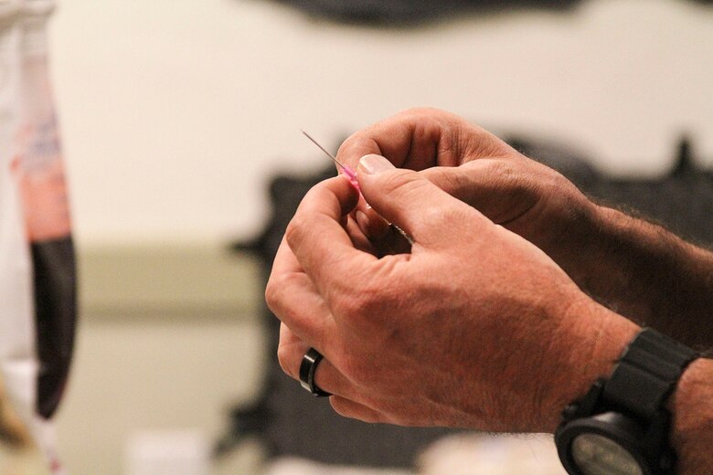 Damon Fiori, from the Glendale Police Department, shows Lance Cpls. Klas Persson and Tobeas Lofberg, Swedish Air Force Medics, various catheters during Tactical Combat Casualty Care training at the Pima County Training Center in Tucson, Ariz., May 6, 2014. TCCC introduces evidence-based, life-saving techniques and strategies for providing the best trauma care on the battlefield.  TCCC is a training event held during Exercise ANGEL THUNDER.  Exercise ANGEL THUNDER is a multilateral annual exercise that to supports DoD’s training requirements for Personnel Recovery responsibilities through high–fidelity exercises. Exercise ANGEL THUNDER provides the most realistic PR training environment available to USAF Rescue forces, as well as their Joint, Interagency, and Coalition partners. Exercise ANGEL THUNDER is collaborating with AF Special Operations Command’s Emerald Warrior exercise and the US Navy 3rd Fleet Joint Warfighting Center training and exercises.   (U.S. Air Force photo by Tech. Sgt. Heather R.Redman/Released)