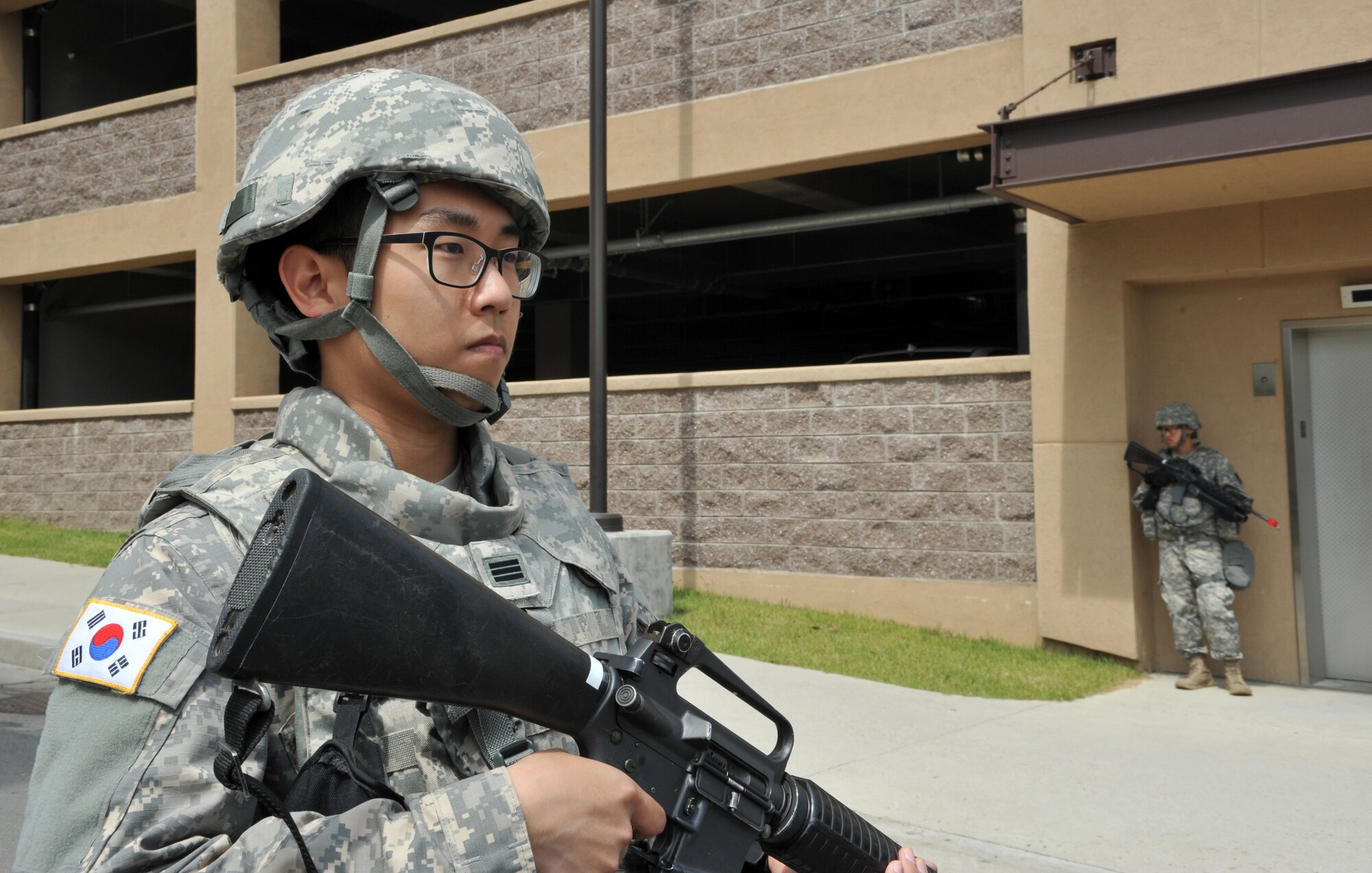 Republic of Korea army Cpl. Sang Woo Kang guards an entry control point after a mock opposition forces scenario during Operational Readiness Exercise Beverly Bulldog 14-02 at Osan Air Base, ROK, May 7, 2014. The U.S. and ROK militaries frequently train together to mimic the flow of operations in a real-world situation. (U.S. Air Force photo/Airman 1st Class Ashley J. Thum)