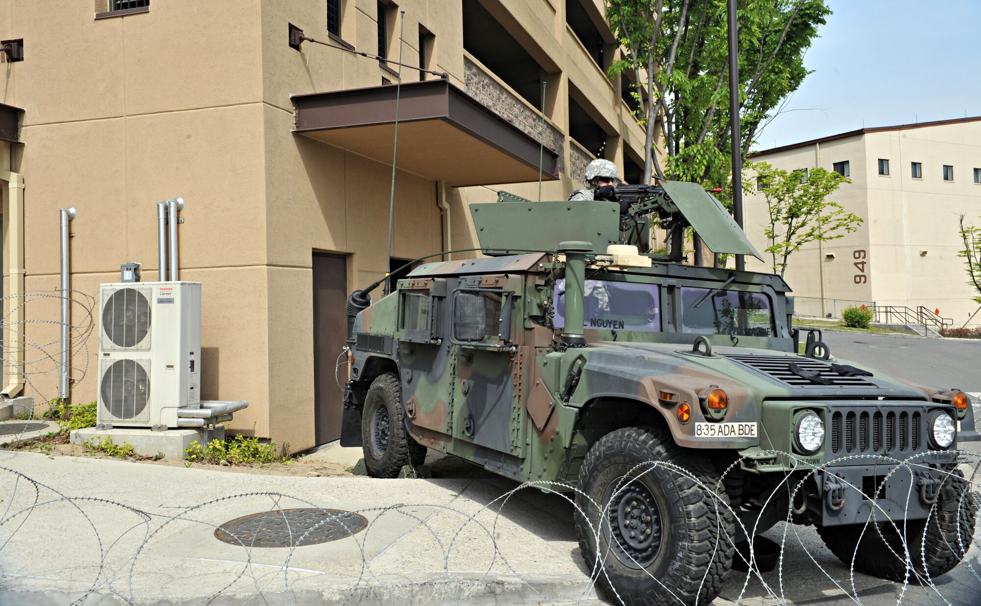 A U.S. Army Soldier scans the area for threats as part of an opposition forces scenario during Operational Readiness Exercise Beverly Bulldog 14-02 at Osan Air Base, Republic of Korea, May 7, 2014. Several Soldiers, including a few from the ROK army, participated in a mock battle with role players near the 3rd Battlefield Coordination Detachment Headquarters. (U.S. Air Force photo/Airman 1st Class Ashley J. Thum)