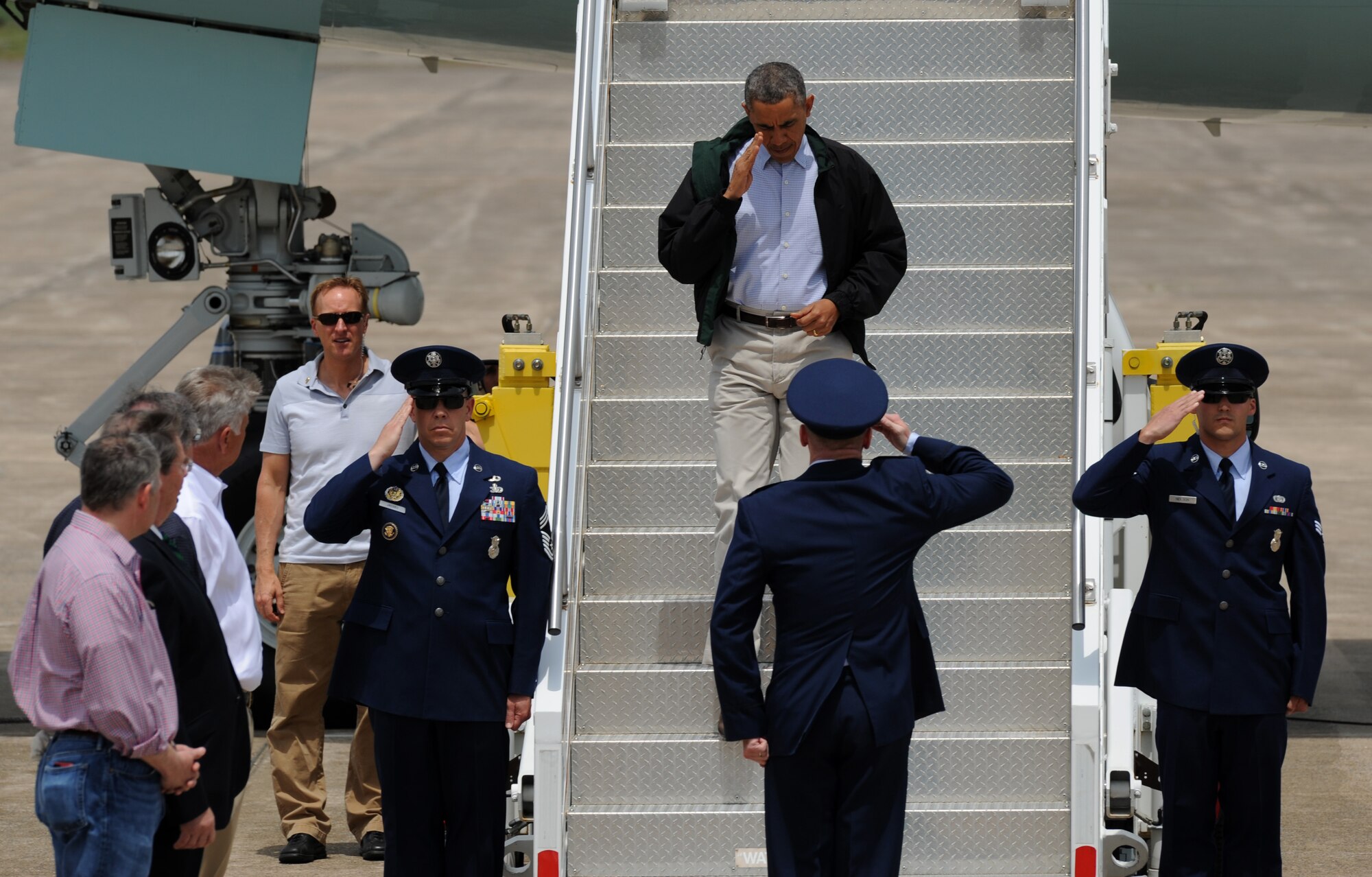 President Barack Obama returns Col. Patrick Rhatigan’s, the 19th Airlift Wing and installation commander, salute May 7, 2014, at Little Rock Air Force Base, Ark. Fifteen people were killed during the April 27 tornado, which tore through Central Arkansas. (U.S. Air Force photo by Airman 1st Class Scott Poe)