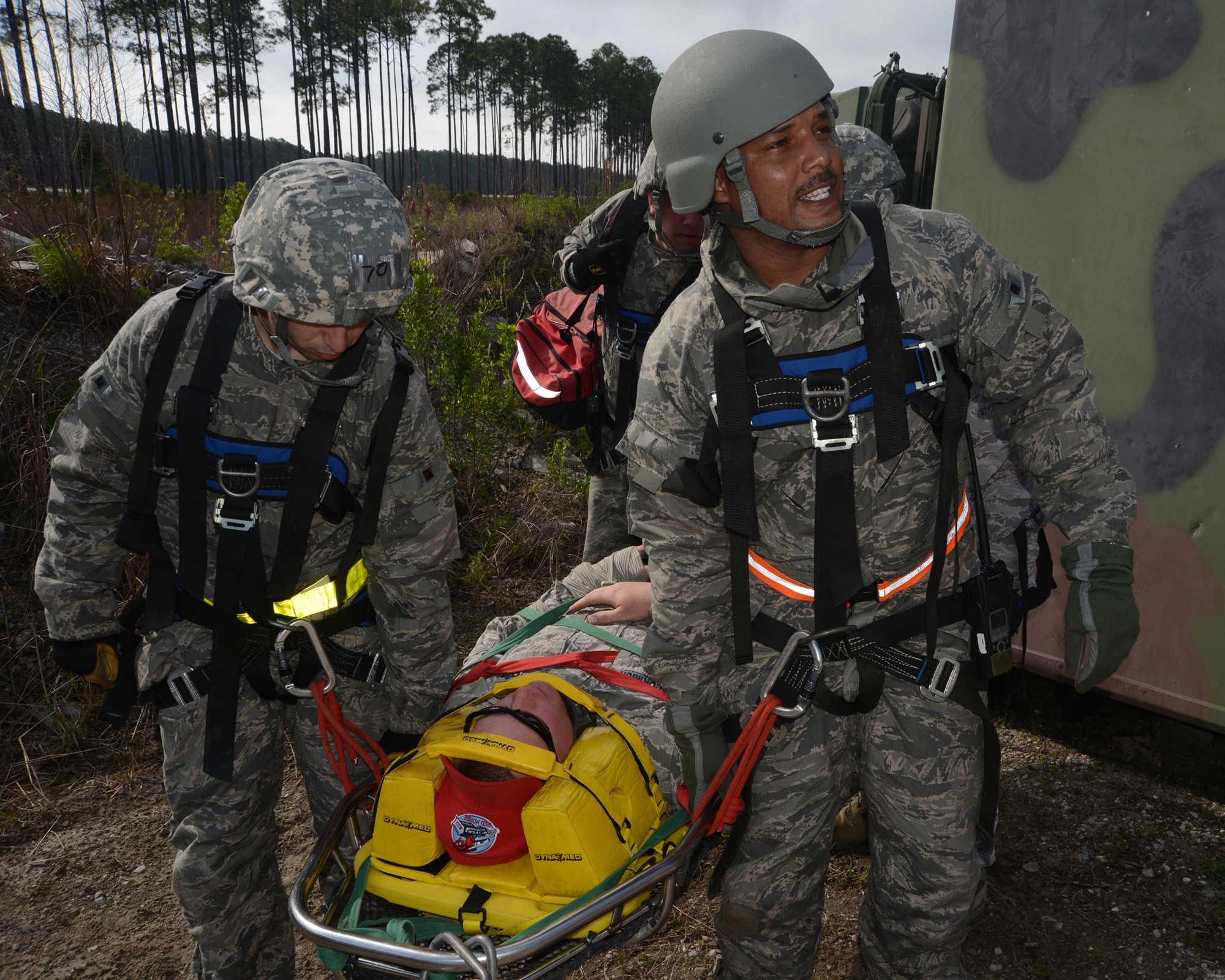 Tech. Sgt. Byron Ball of the 319th Civil Engineer Squadron, right, shouts directions as Senior Airman Nicholas Verdi, assists him with rescue procedures for simulated accident victim Staff Sgt. Adam McCormick, a Det. 1, 823d RED HORSE Squadron instructor, during a training exercise at the Silver Flag site on Tyndall Air Force Base, Fla., April 3, 2014. (U.S. Air Force photo/Senior Master Sgt. David H. Lipp)
