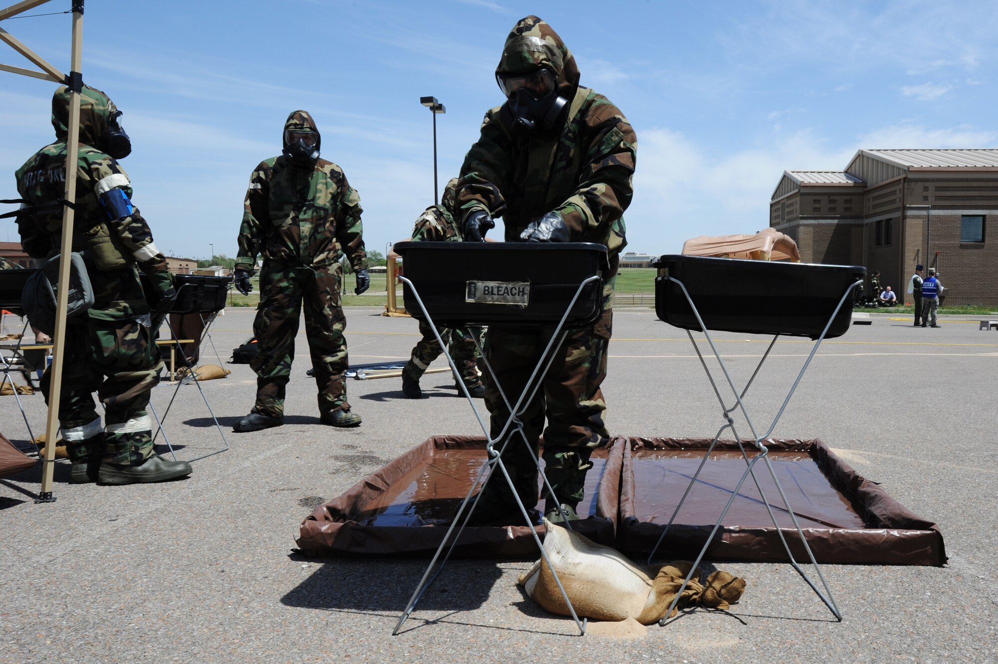 Senior Airman Andrew Reed, goes through 22nd Aircraft Maintenance Squadron avionics specialist goes through the decontamination process during training May 6, 2014, at McConnell Air Force Base, Kan. This kind of training is designed to prepare Airmen for possible combat scenarios. (U.S. Air Force photo/Airman 1st Class Aaron-Forrest Wainwright) 