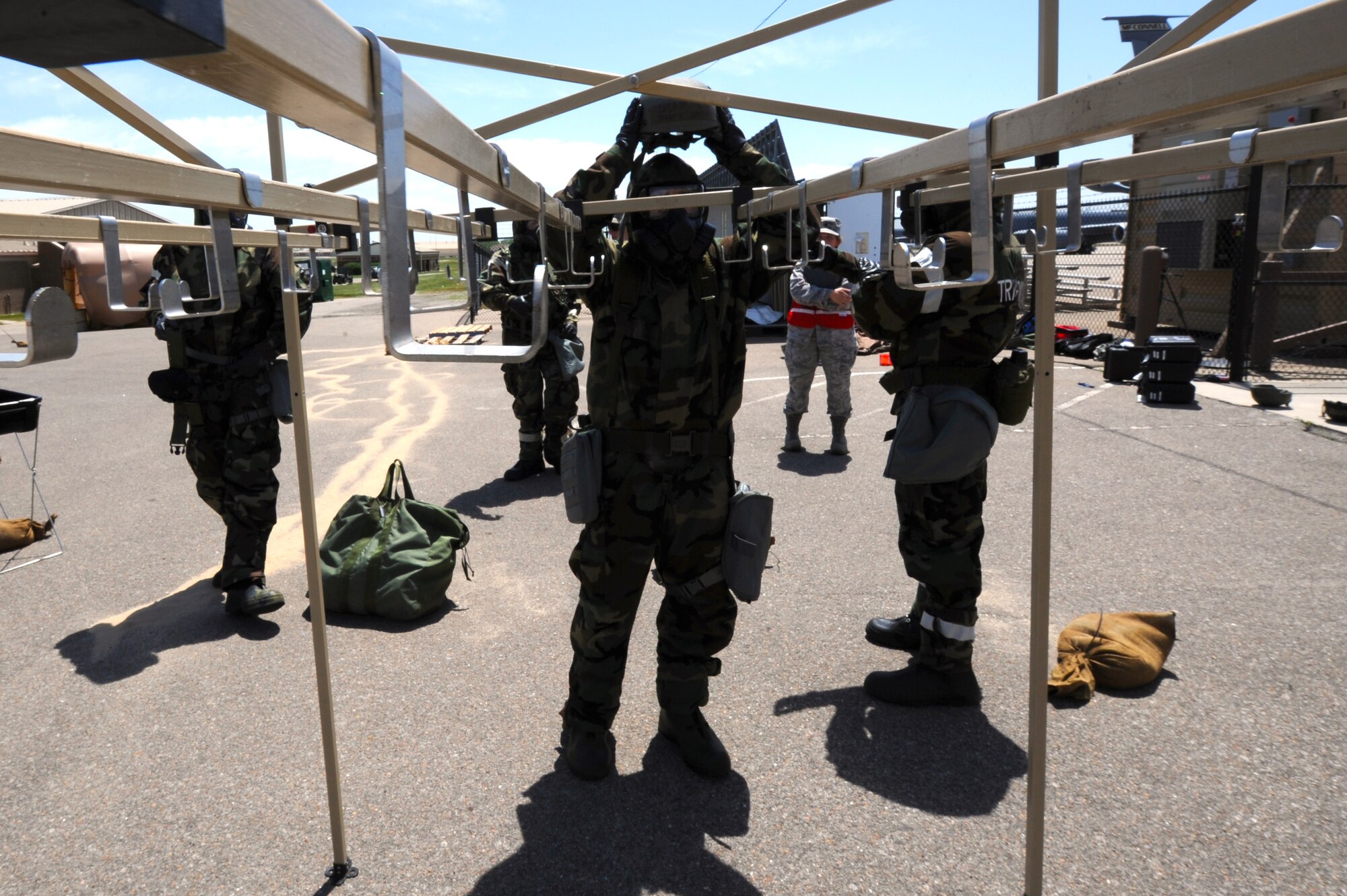 Senior Airman Andrew Reed, goes through 22nd Aircraft Maintenance Squadron avionics specialist goes through the decontamination process during training May 6, 2014, at McConnell Air Force Base, Kan. This kind of training is designed to prepare Airmen for possible combat scenarios. (U.S. Air Force photo/Airman 1st Class Aaron-Forrest Wainwright) 