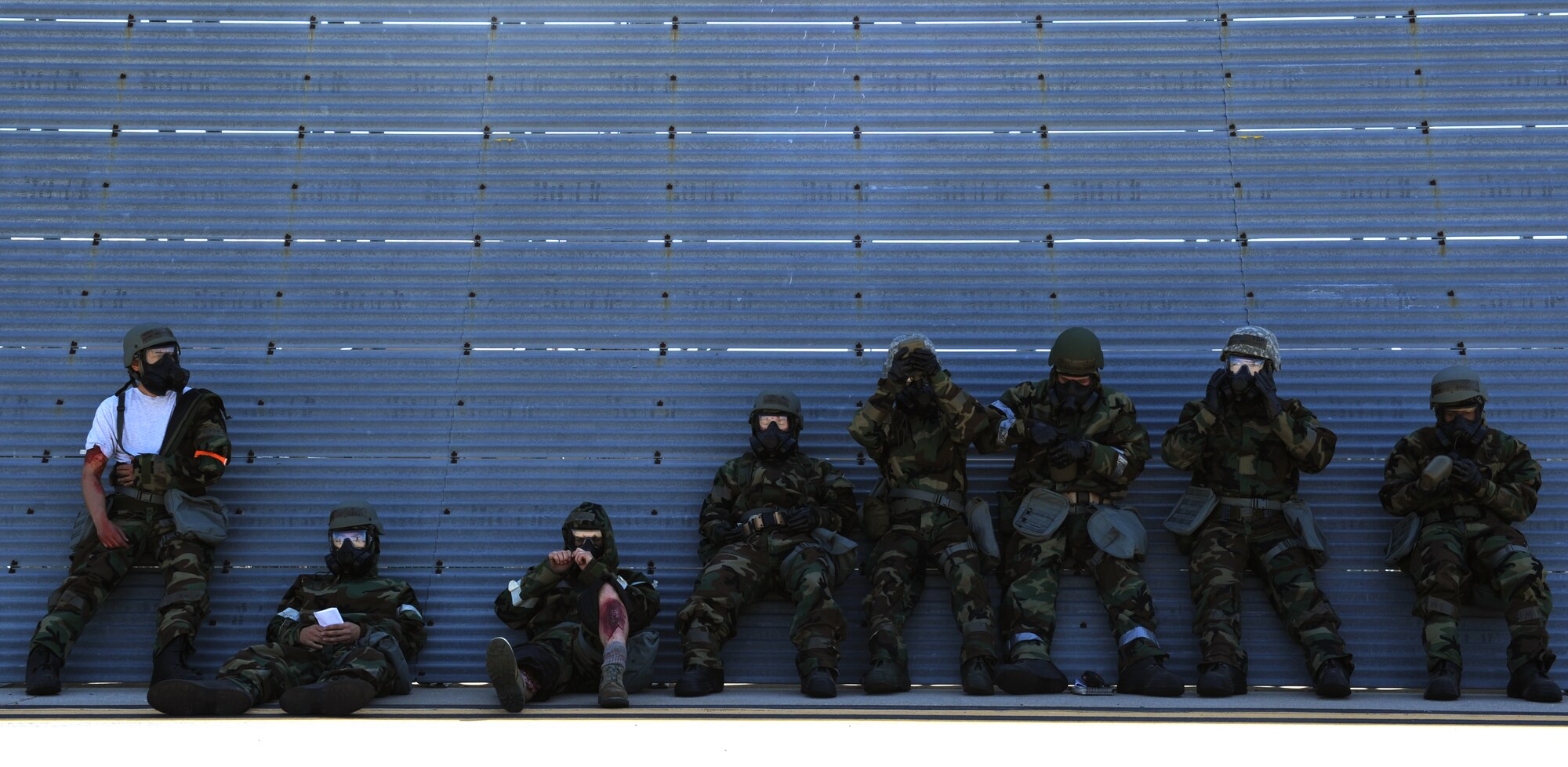 Airmen await further instruction during during training, May 6, 2014, at McConnell Air Force Base, Kan. This kind of training is designed to prepare Airmen for possible combat scenarios. (U.S. Air Force photo/Airman 1st Class Aaron-Forrest Wainwright) 