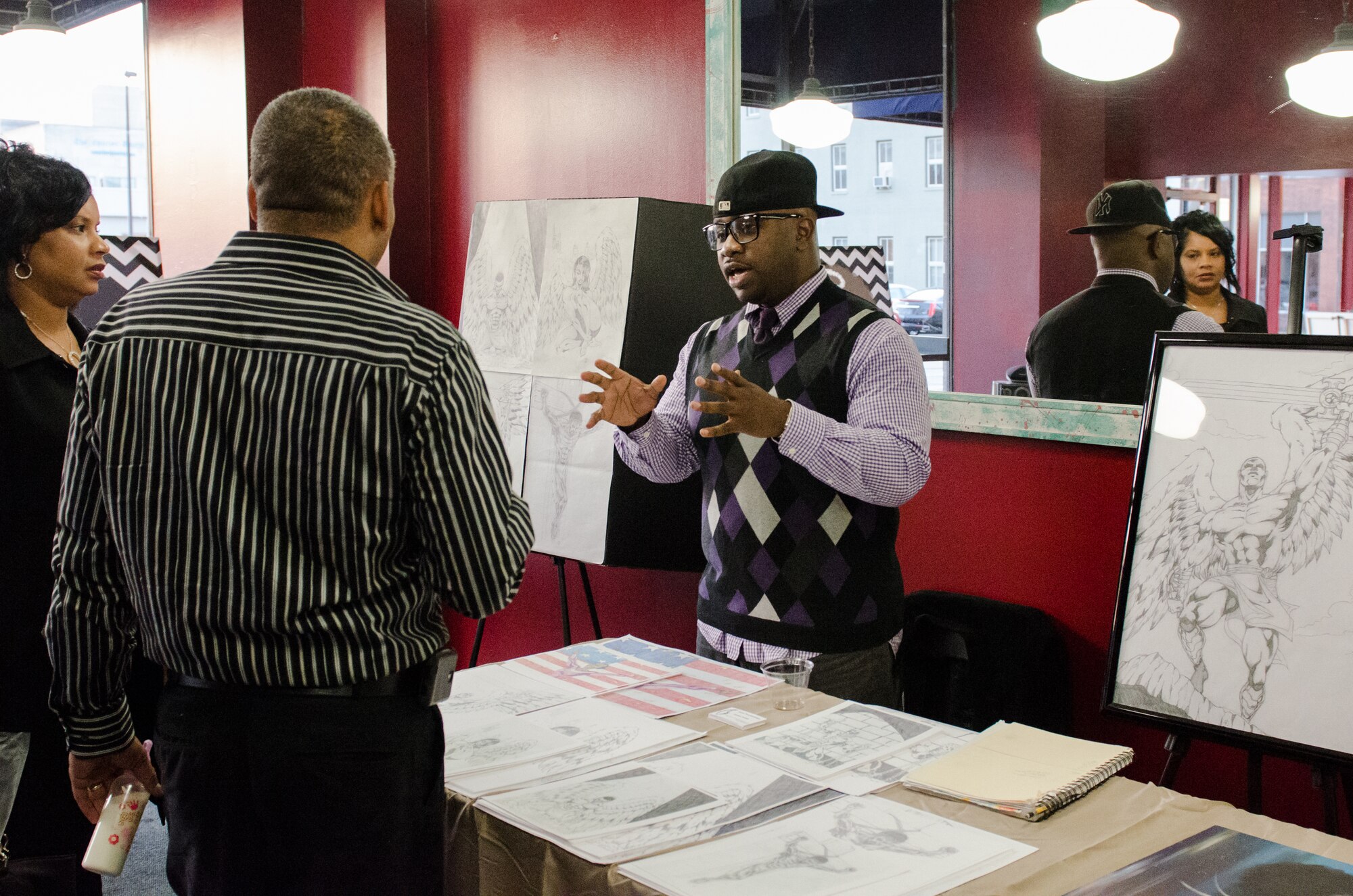Staff Sgt. James Scott, an administrative assistant with the Kentucky Air National Guard’s 123rd Airlift Wing, displays his sketches and drawings at the annual Black Angels Art Exhibit in Louisville, Ky., Dec. 1, 2013. Scott is hoping to publish a collection of his drawings in a future book. (U.S. Air National Guard photo by Airman 1st Class Joshua Horton)