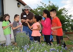 Bryan Hummel (center), 502nd Civil Engineer Squadron natural resources manager, gives Randolph Elementary School students a gardening lesson April 23. 
(U.S. Air Force photo by Melissa Peterson)
