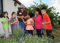 Bryan Hummel (center), 502nd Civil Engineer Squadron natural resources manager, gives Randolph Elementary School students a gardening lesson April 23. 
(U.S. Air Force photo by Melissa Peterson)
