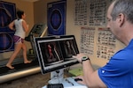 Karl Leonard, Health and Wellness Center exercise physiologist, monitors Master Sgt. Karla Iglesias, 359th Aerospace Medical Squadron, on her running technique during her gait evaluation efficiency lab test April 25 at Joint Base San Antonio-Randolph. (U.S. Air Force photo by Johnny Saldivar)

