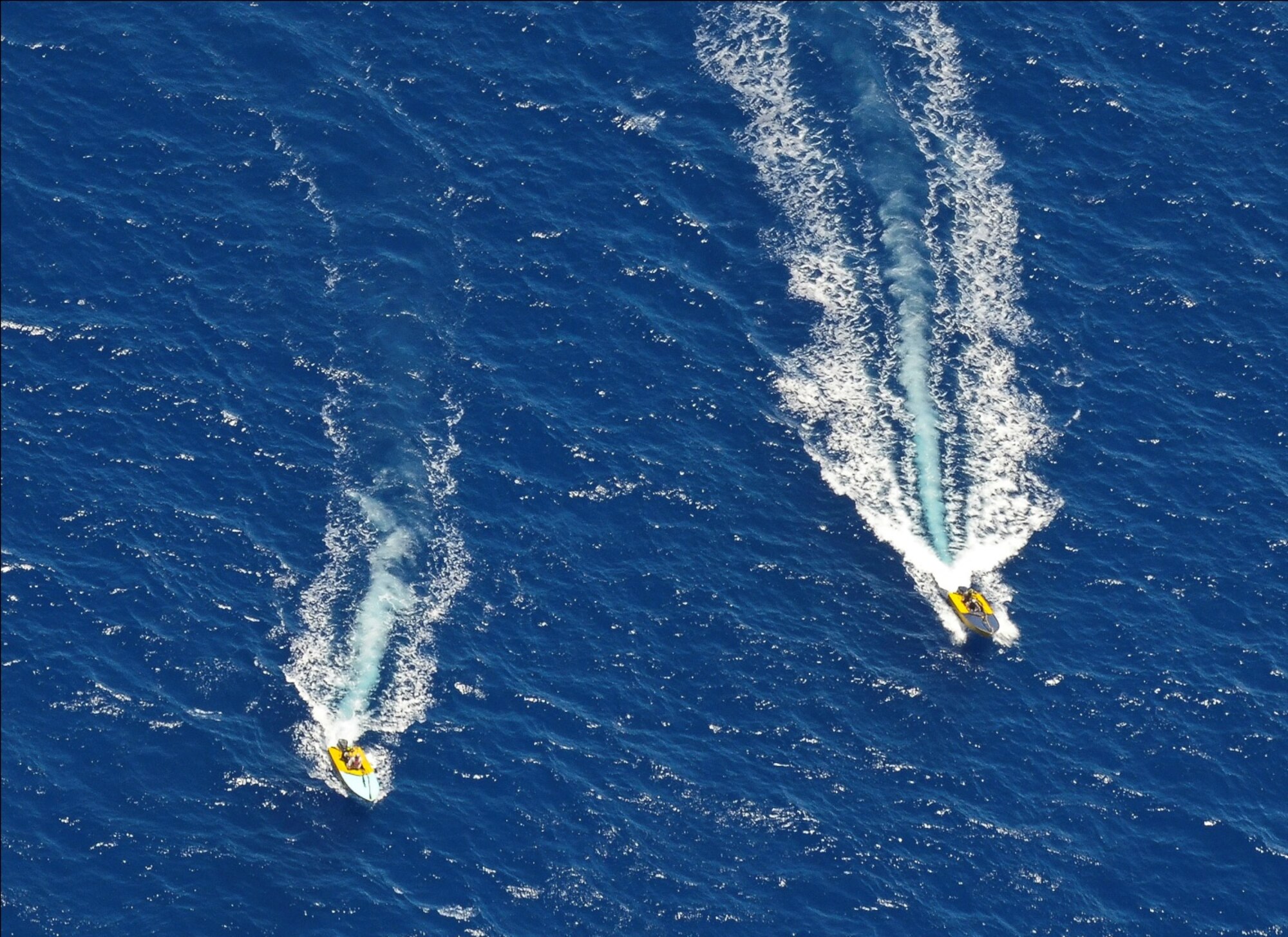 Pararescuemen from the 48th Rescue Squadron (RQS) utilize fastboats from the Venezuelan fishing vessel to position a skiff to a location for the safety of hoist extraction operations by two HH-60G Pavehawk helicopters from the 55th RQS during a rescue mission on May 5, 2014, off the Pacific Coast of Mexico. The PJs are the only Department of Defense combat forces specifically organized, trained, equipped, and postured to conduct full spectrum personnel recovery operations. (U.S. Air Force photo by Staff Sgt. Adam Grant/Released)