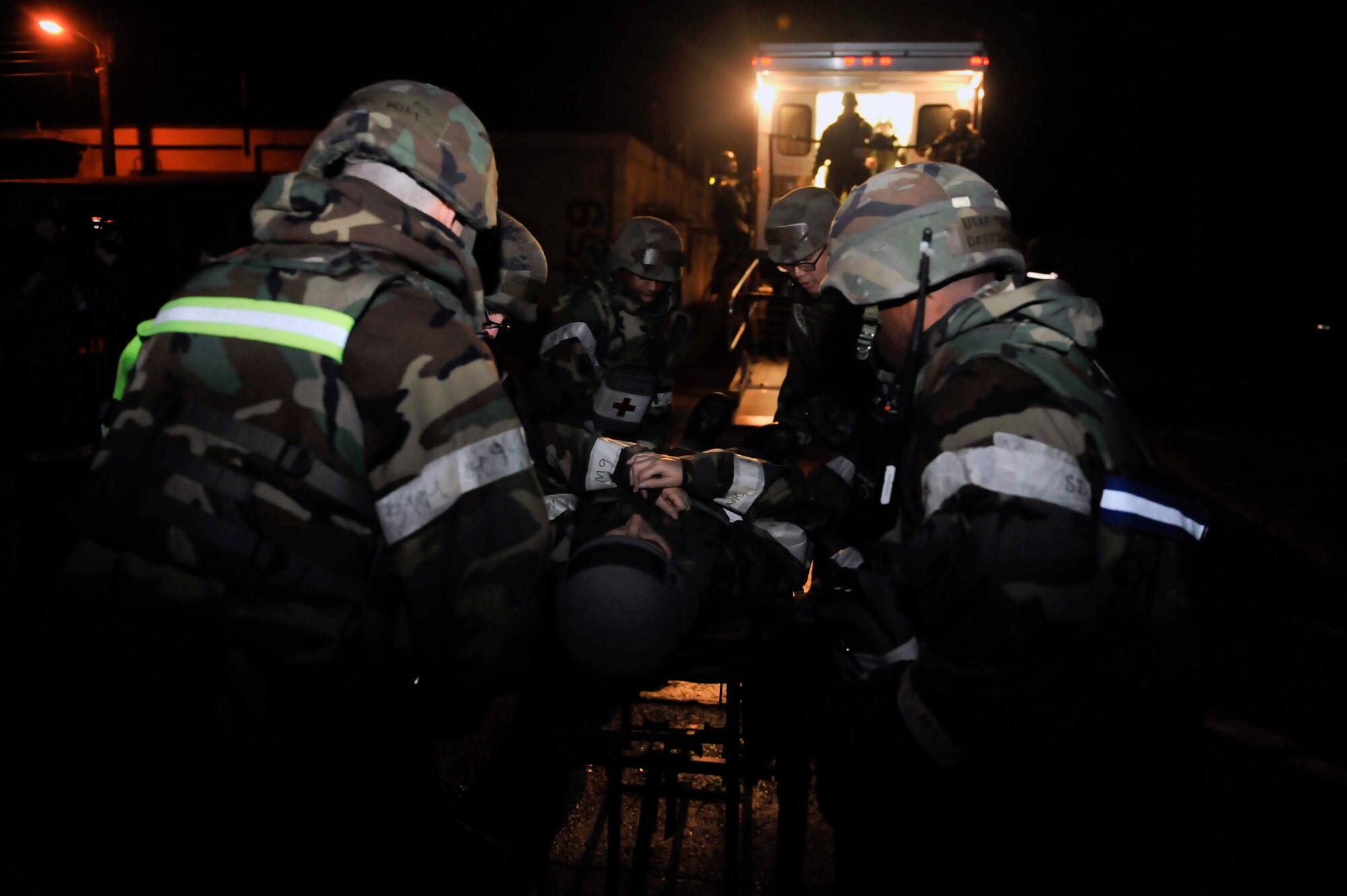 Airmen from the 51st Medical Group place a patient onto a NATO litter carrier May 8 near the emergency room during a simulated patient transfer on Osan Air Base, Republic of Korea. The carrier allows for only two members to take patients instead of four members. The vehicle provides space to transfer up to six patients on NATO litters and 10 additional ambulatory patients. (U.S. Air Force photo by Senior Airman David Owsianka)