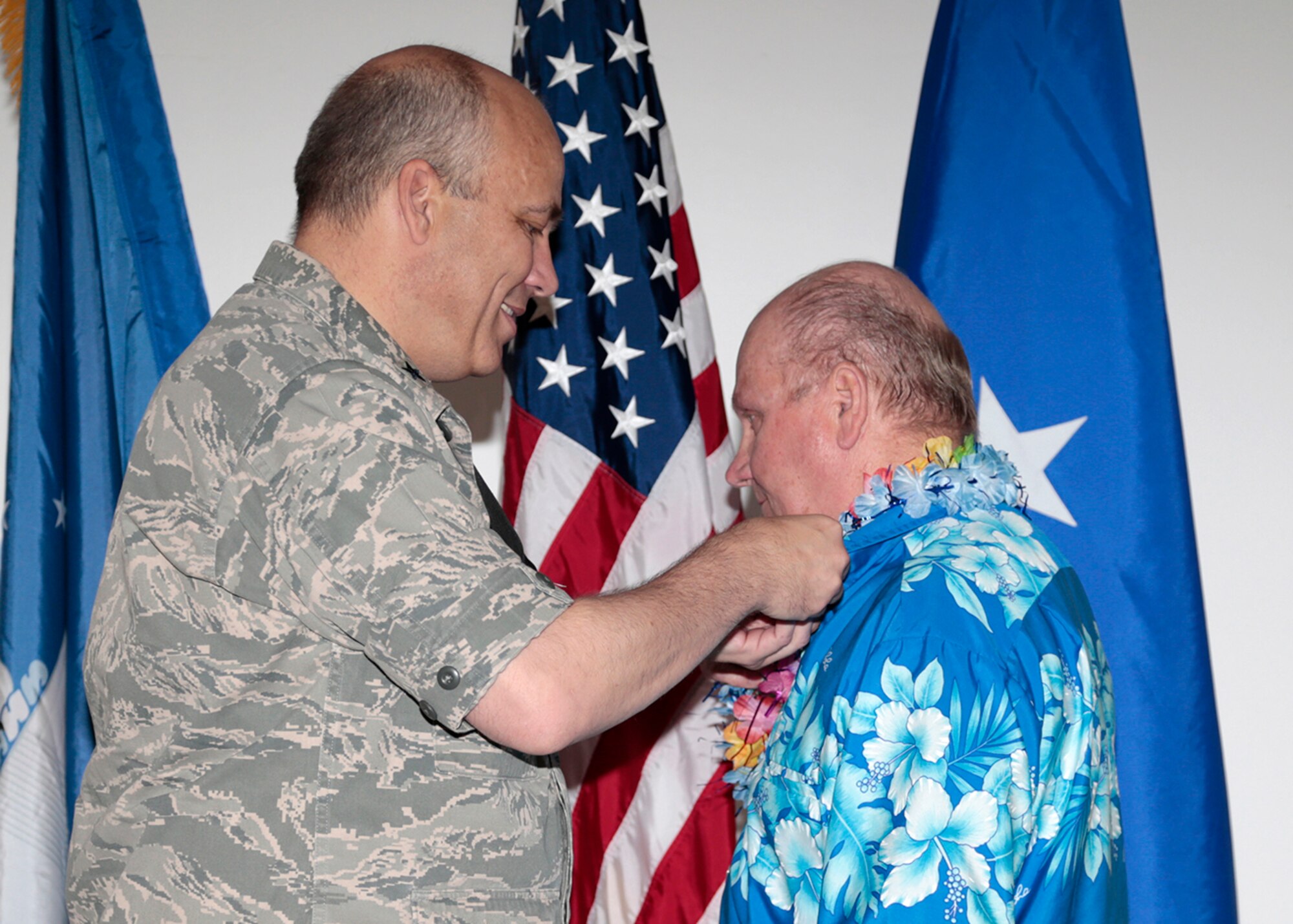 Brig. Gen. Michael T. Brewer, 412th Test Wing commander, pins a retirement pin on Russell Koche May 1. Koche retired after more than 50 years of federal service. (U.S. Air Force photo by Christian Turner) 