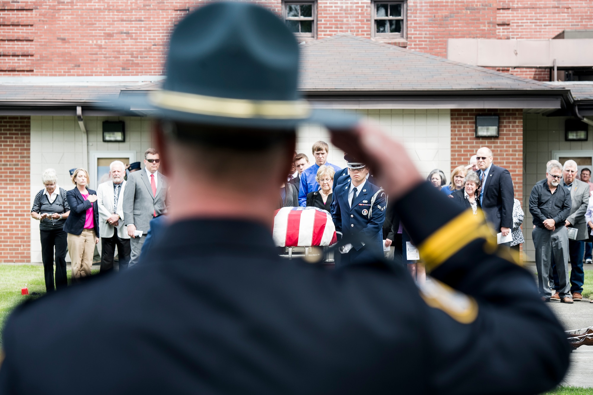 Joint Base Lewis-McChord Police officer Lt. Robert Rothrock salutes the casket of Air Force Capt. Douglas D. Ferguson May 2, 2014, as the McChord Honor Guard transfers Ferguson's remains to the hearse following the funeral service at Joint Base Lewis-McChord, Wash. Ferguson was later laid to rest close to where his parents were buried at Mountain View Funeral Home in Lakewood, Wash. (U.S. photo/Tech. Sgt. Sean Tobin)