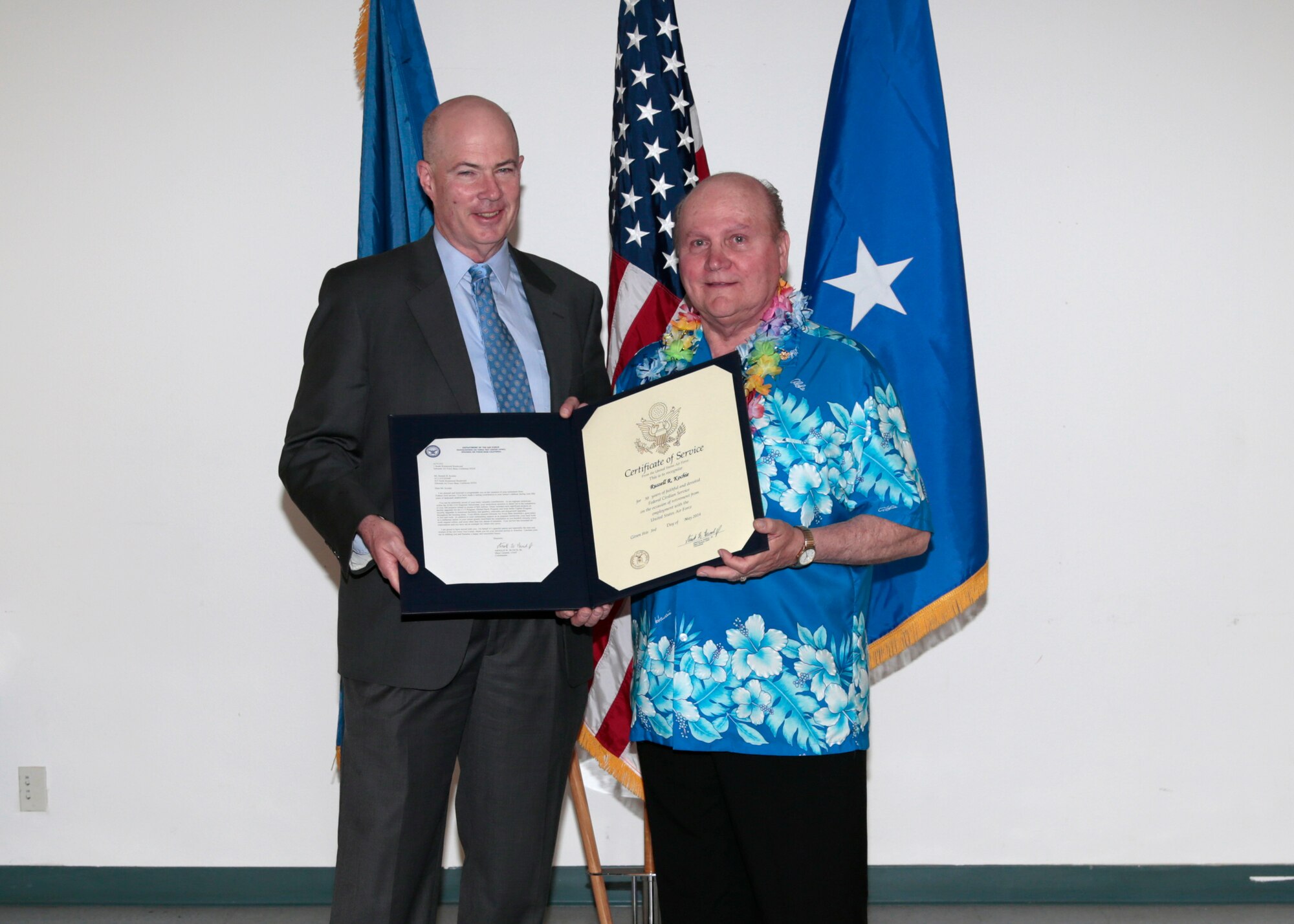 Russell Koche (right), poses for a photo with James Judkins, 412th Civil Engineering director, following Koche's retirement ceremony May 1 at Chapel 1. Koche received his retirement certificate for more than 50 years of federal service, all at Edwards AFB. (U.S. Air Force photo by Christian Turner)