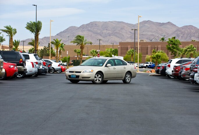 A privately owned vehicle parks at the Warrior Fitness Center May 5 at Nellis Air Force Base, Nev. Starting on June 1, all vehicles that drive on Nellis AFB over 60 days per year will be required to register on the new Employee-vehicle Certification and Reporting System program. ECARS is an air emission inventory and emission reporting program to monitor and help eliminate pollution in the area. (U.S. Air Force photo illustration by Airman 1st Class Jake Carter)