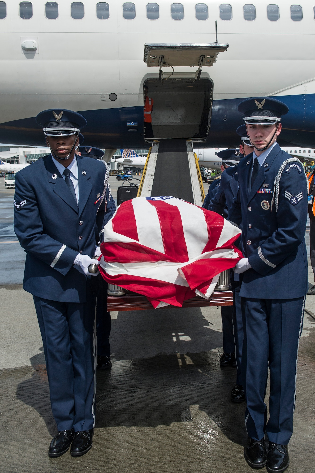 Members of the McChord Field Honor Guard transfer the remains of Air Force Capt. Douglas D. Ferguson to an awaiting hearse May 1, 2014, at Seattle-Tacoma Airport in SeaTac, Wash. Ferguson, a native of Tacoma, Wash., had been missing since his airplane was shot down over Laos Dec. 30, 1969. (U.S. Air Force photo/Tech. Sgt. Sean Tobin)