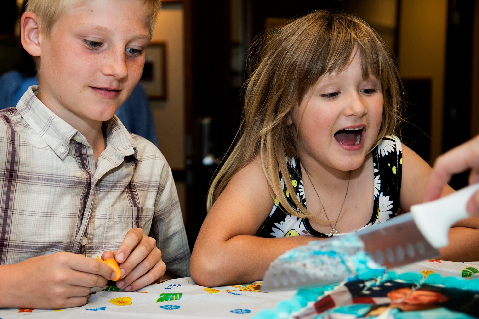 Peter and Margaret Van Hoy wait for a slice of cake following the 93rd Bomb Squadron Change of Command ceremony, May 6, 2014, Barksdale Air Force Base, La. Their dad, U.S. Air Force Lt. Col. Robert Van Hoy II, is a B-52H Stratofortress pilot and assumed command of the squadron. (U.S. Air Force photo by Master Sgt. Greg Steele/Released)