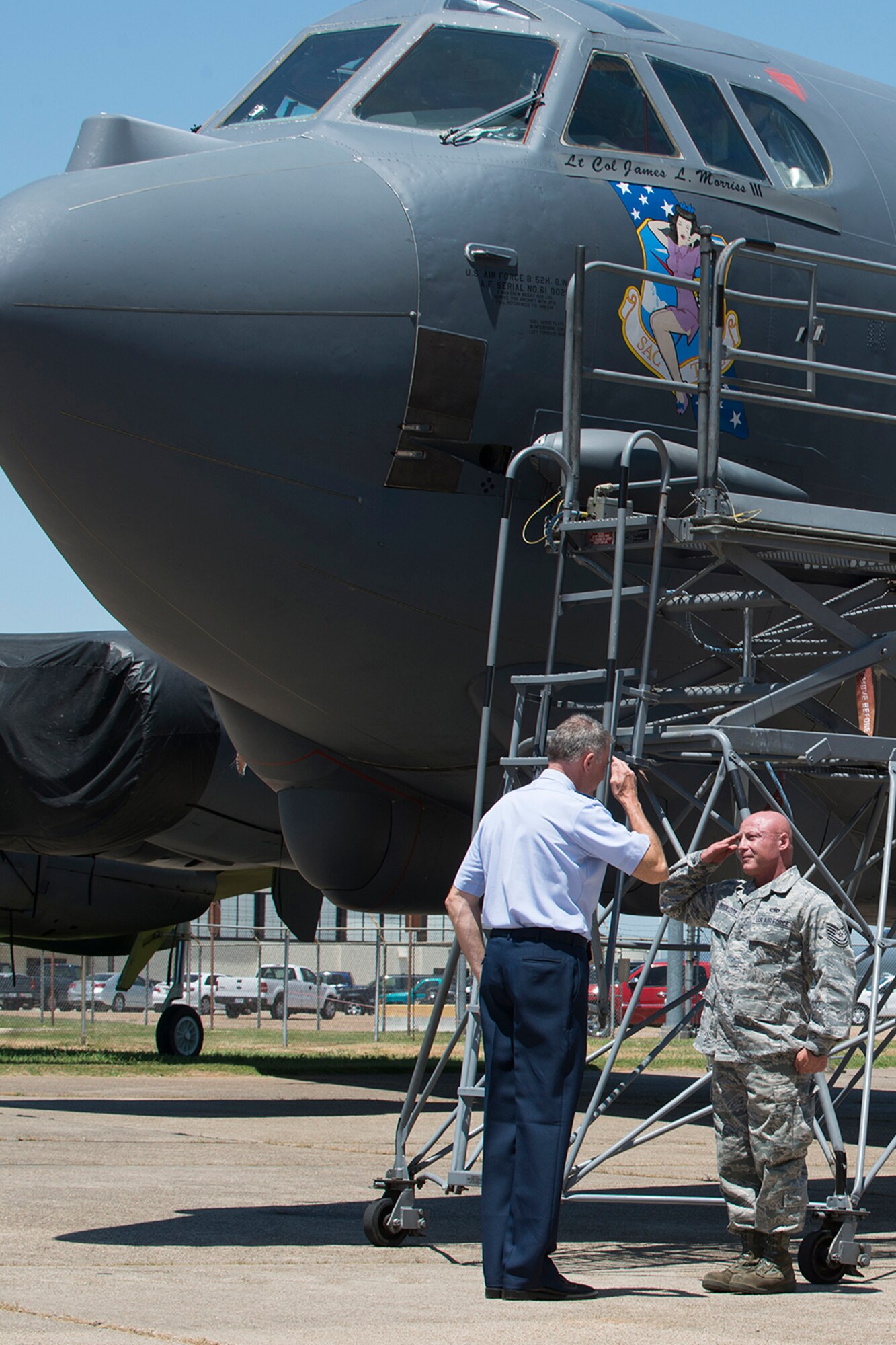 U.S. Air Force Lt. Col. Robert Van Hoy, 93rd Bomb Squadron (BS) commander, salutes Tech. Sgt. Jessie Brouillette, 307th Aircraft Maintenance Squadron crew chief, before the unveiling of his name of the side of a B-52H Stratofortress, May 6, 2014, Barksdale Air Force Base, La. Van Hoy assumed command of the 93rd BS during a Change of Command ceremony prior to the unveiling. (U.S. Air Force photo by Master Sgt. Greg Steele/Released)