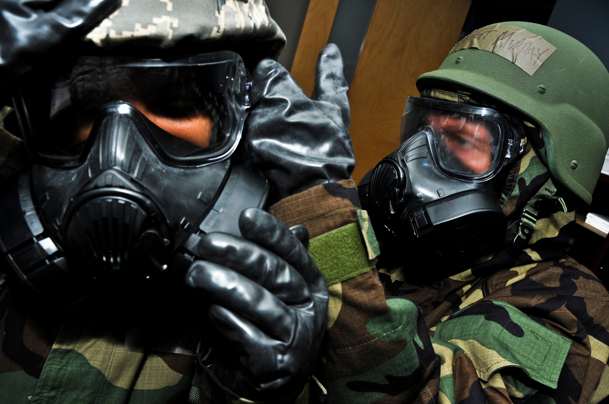 During a chemical weapons exercise, Staff Sgt. Alex Murray assists fellow 911th Operations Group member Senior Airman Shalimar Horne don his Mission Oriented Protective Posture (MOPP) Level Four gear at the Pittsburgh International Airport Air Reserve Station, May 4, 2014. The exercise was conducted as part of the new Commanders’ Inspection Program that allows the 911th Airlift Wing to perform graded exercises at home station rather than using vital funds to send Airmen to other bases for inspection. (U.S. Air Force photo by Senior Airman Joshua J. Seybert)